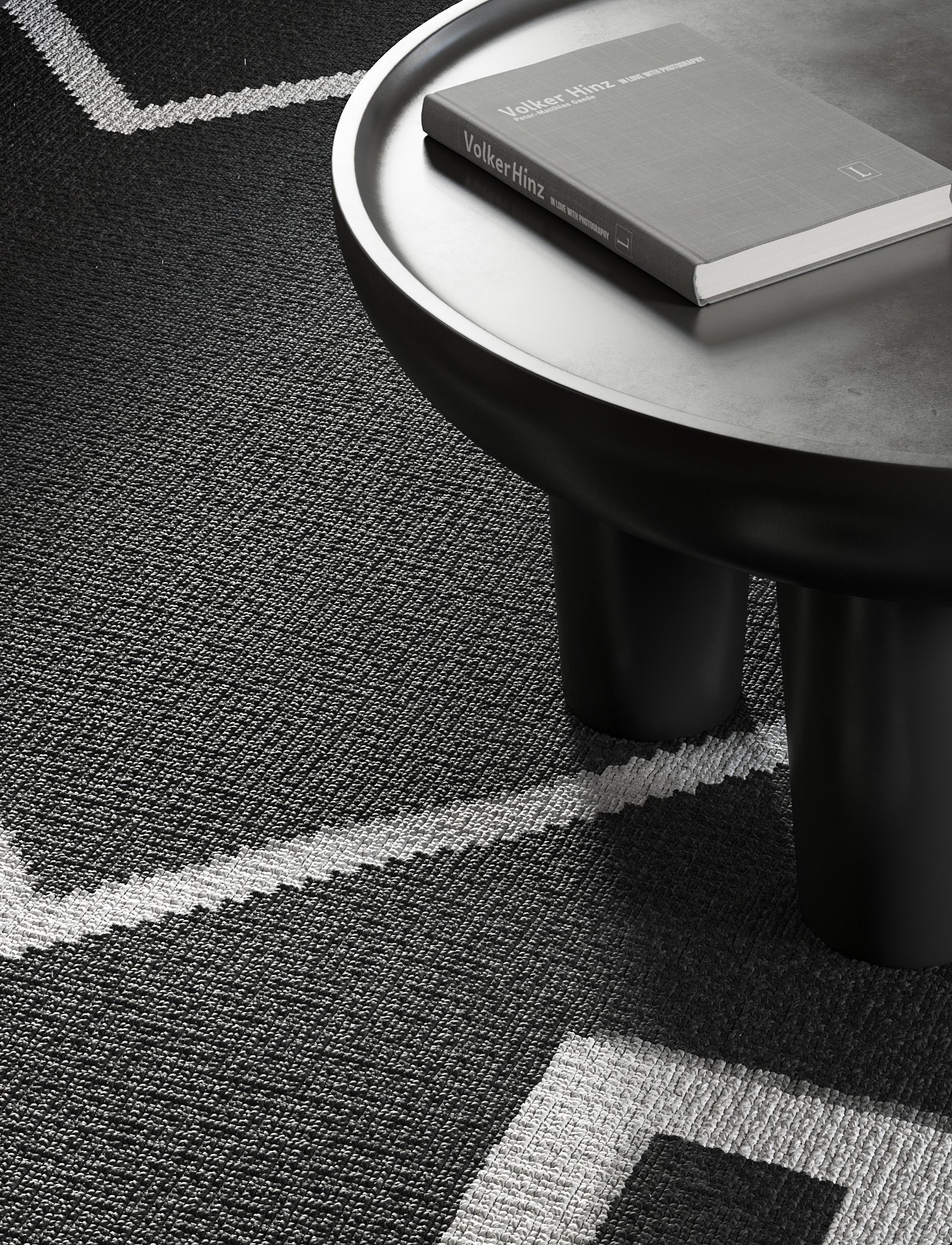 Black coffee table with a book on a patterned rug